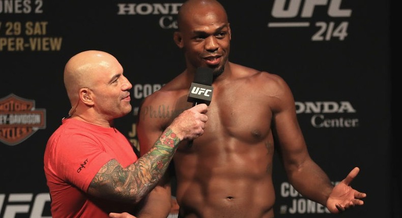 Commentator Joe Rogan speaks with Jon Jones during the UFC 214 weigh-in.