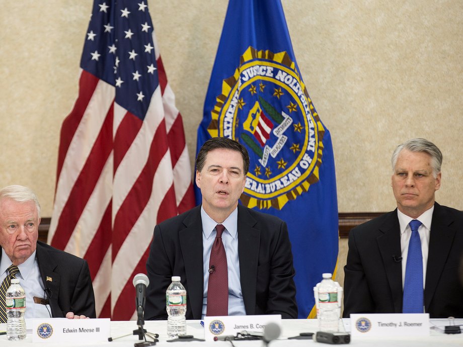 FBI Director James B. Comey (C), Commissioner Edwin Meese III (L), and Commissioner Timothy J. Roemer speak during a news conference on the release of the 9/11 Review Commission report in Washington March 25, 2015. The FBI needs to strengthen its intelligence programs and information sharing to counter the diverse and fast-moving national threats that have evolved since the Sept. 11, 2001, attacks, a congressional commission said