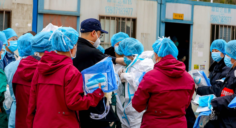 wuhan coronavirus medical worker protective suit sports center arena