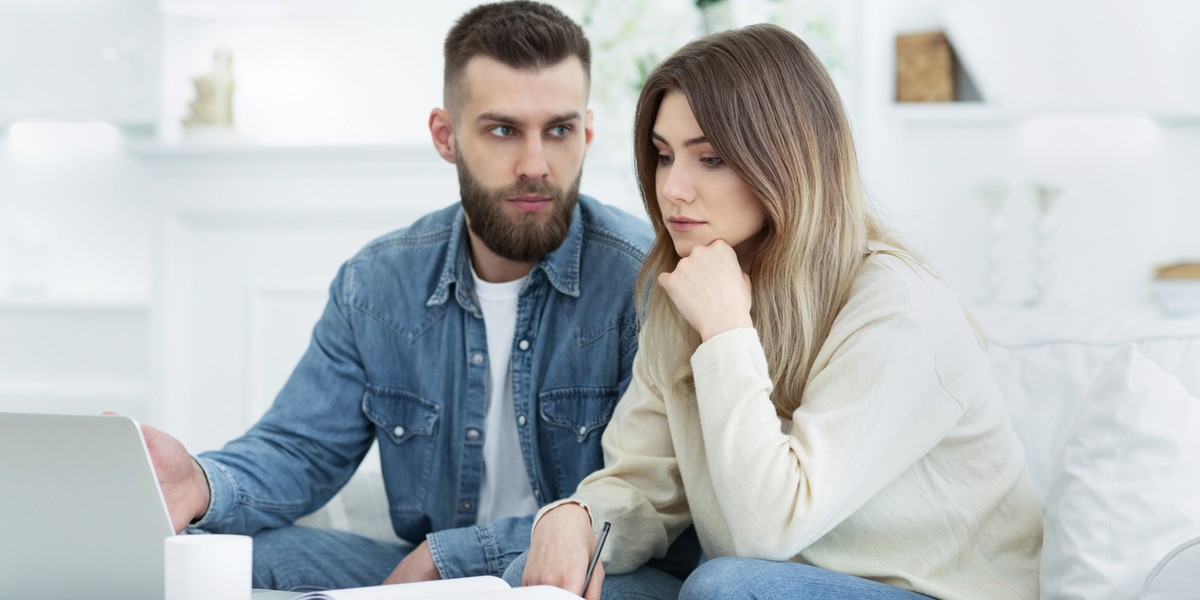 Worried family managing finances on laptop at home