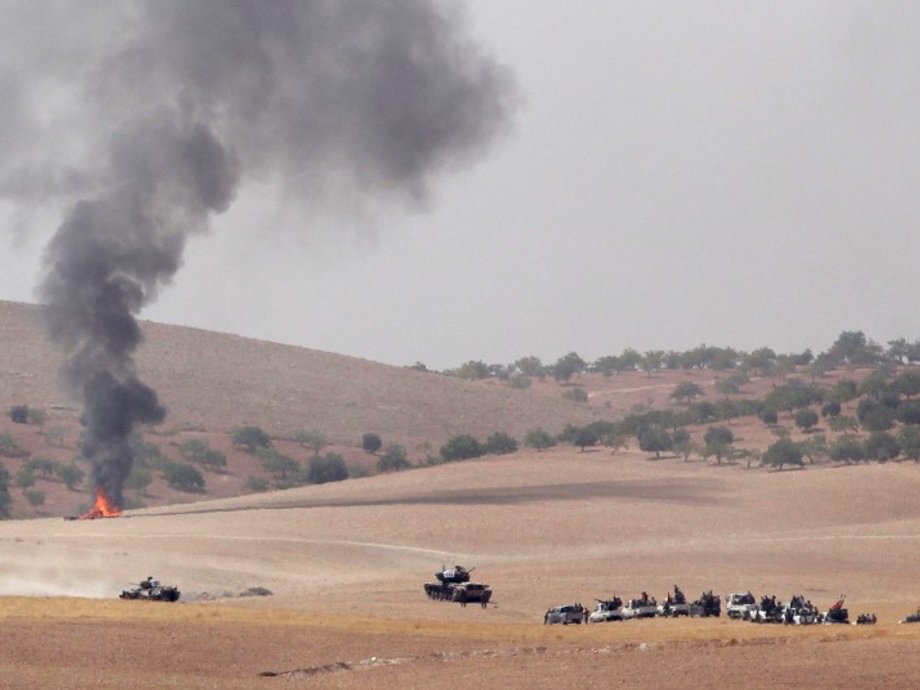 Turkish army tanks and Turkish-backed Syrian fighters near the Syrian border town of Jarablus on Wednesday.