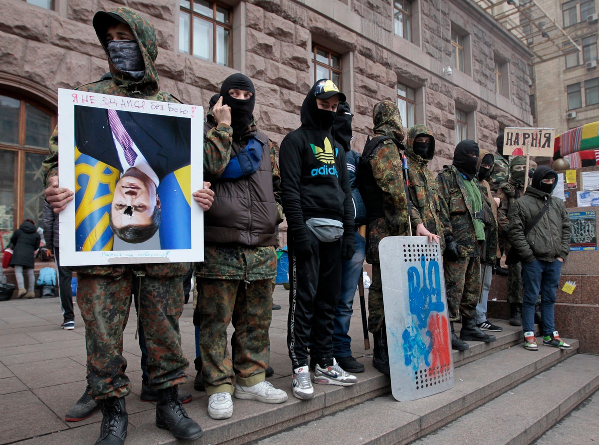 Wiktor Janukowycz do góry nogami. Protestujący na Majdanie trzymają portret prezydenta Ukrainy