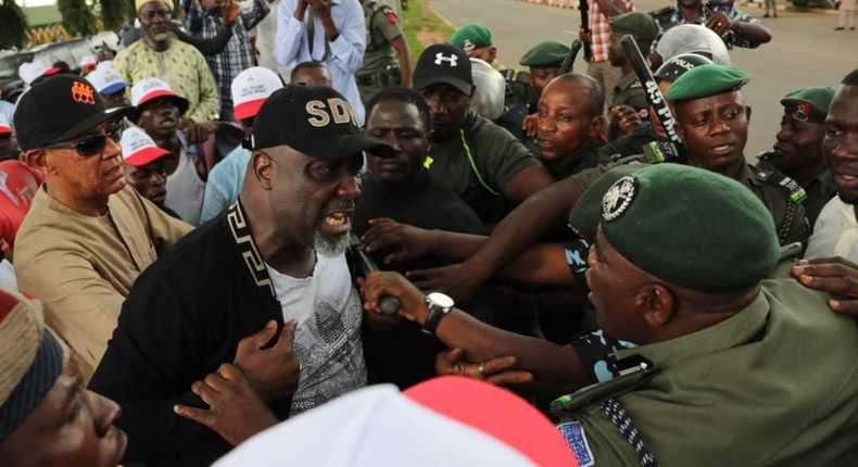 Senator Dino Melaye clashes with police officers at Abuja protest