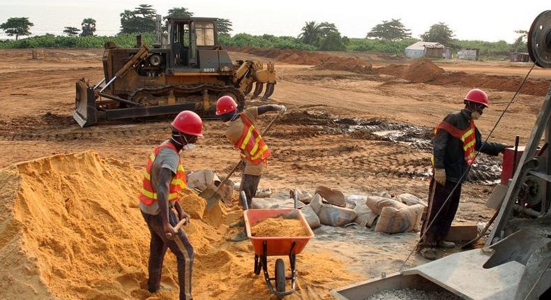 Labourers mix cement at the site of a new port to be built in the oil-producing Angolan exclave of Cabinda, June 11, 2016. Picture taken June 11, 2016. 