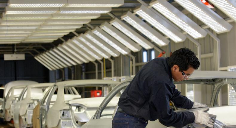 An employee works on the assembly line at the Volkswagen (VW) automobile manufacturing factory in Puebla August 12, 2010. Puebla, which will manufacture over half a million vehicles every year, is VW's largest factory in the Americas and one of the largest worldwide.