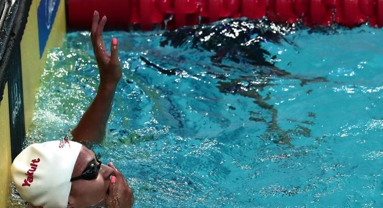 Canada's Kylie Masse celebrates a new world record after the women's 100m backstroke final on July 25, 2017