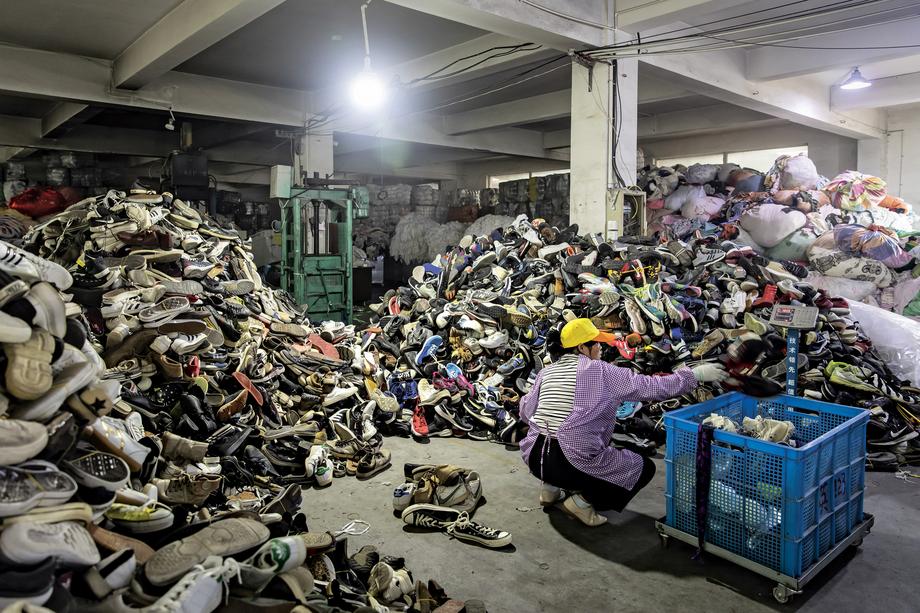 RECYCLING Sorting used shoes at a second-hand clothes trading fi rm in China. Consumers have become increasingly concerned about the amount of waste and environmental damage produced by the clothing industry around the world