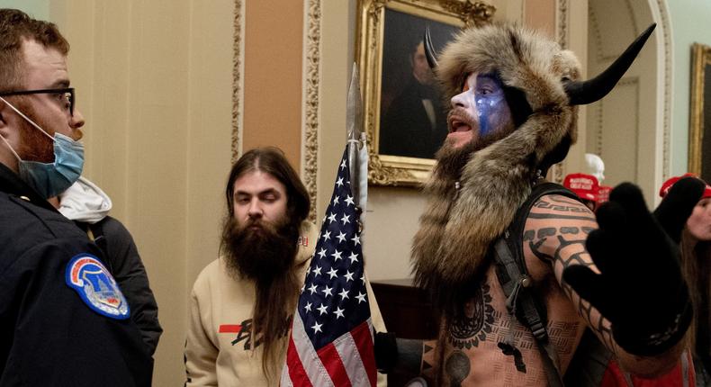 Jake Angeli, the Q Shaman, was one of several protesters to confront Capitol police officers at the US Capitol on January 6, 2021, in Washington, DC. - Demonstrators breached security and entered the Capitol as Congress debated the a 2020 presidential election Electoral Vote Certification.
