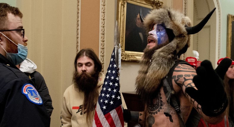 Jake Angeli, the Q Shaman, was one of several protesters to confront Capitol police officers at the US Capitol on January 6, 2021, in Washington, DC. - Demonstrators breached security and entered the Capitol as Congress debated the a 2020 presidential election Electoral Vote Certification.