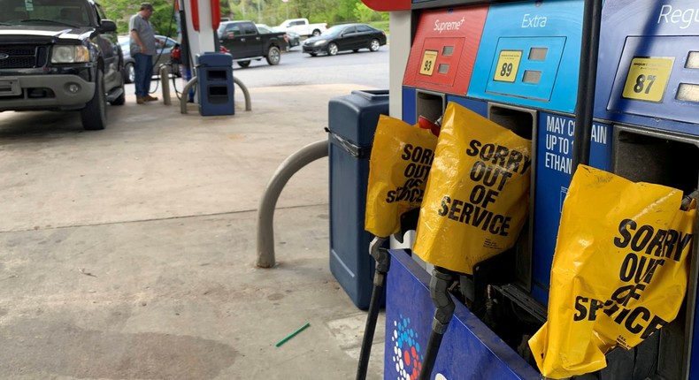 Out of service fuel nozzles are covered in plastic on a gas pump at a gas station in Waynesville, North Carolina, after a gasoline supply crunch caused by the Colonial Pipeline hack
