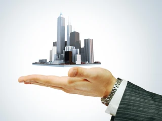 Business city center in businessman's hand