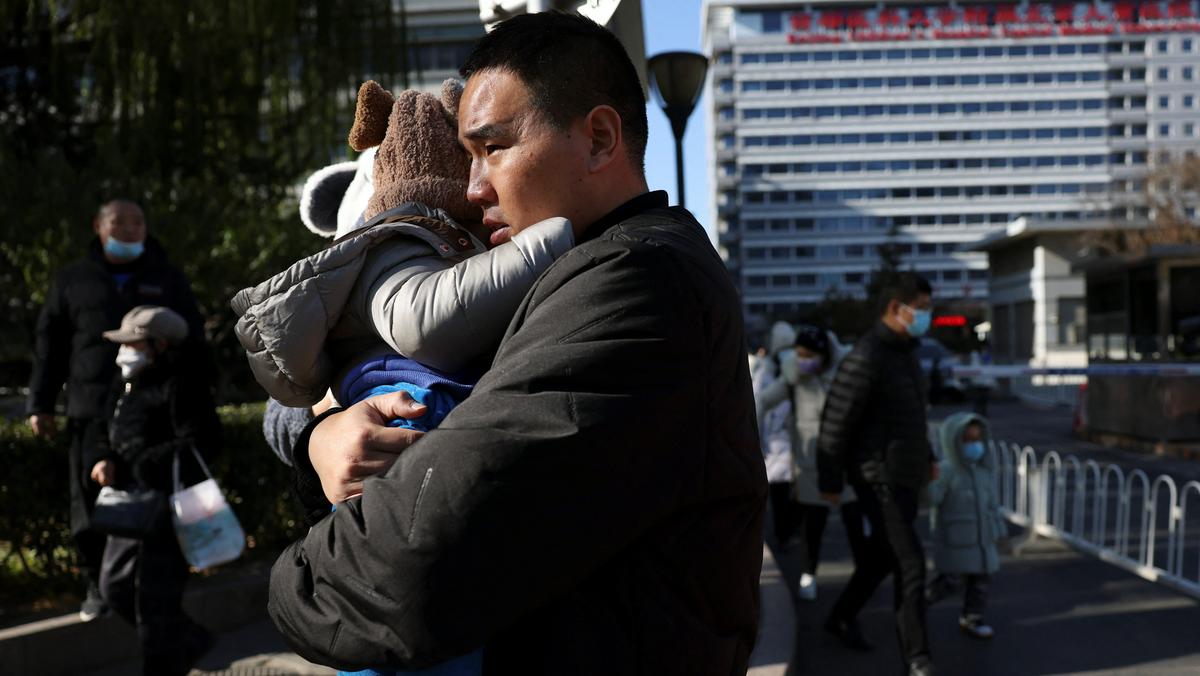Ojciec z dzieckiem przed szpitalem dziecięcym w Pekinie