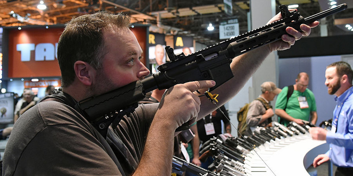 Tyler Burton tries out an M&P 15-22 Sport rifle at the Smith & Wesson booth at the 2016 National Shooting Sports Foundation's Shooting, Hunting, Outdoor Trade (SHOT) Show.