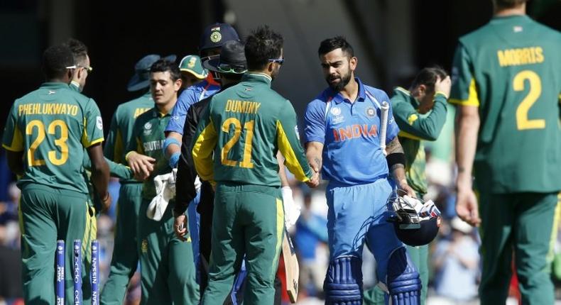 India's captain Virat Kohli (C-R) shakes hands with South Africa's JP Duminy after their ICC Champions Trophy match, at The Oval in London, on June 11, 2017