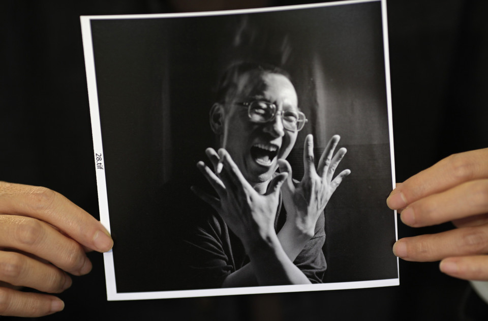 A photograph of Chinese dissident Liu Xiaobo is held by his wife Liu Xia during an interview in Beijing