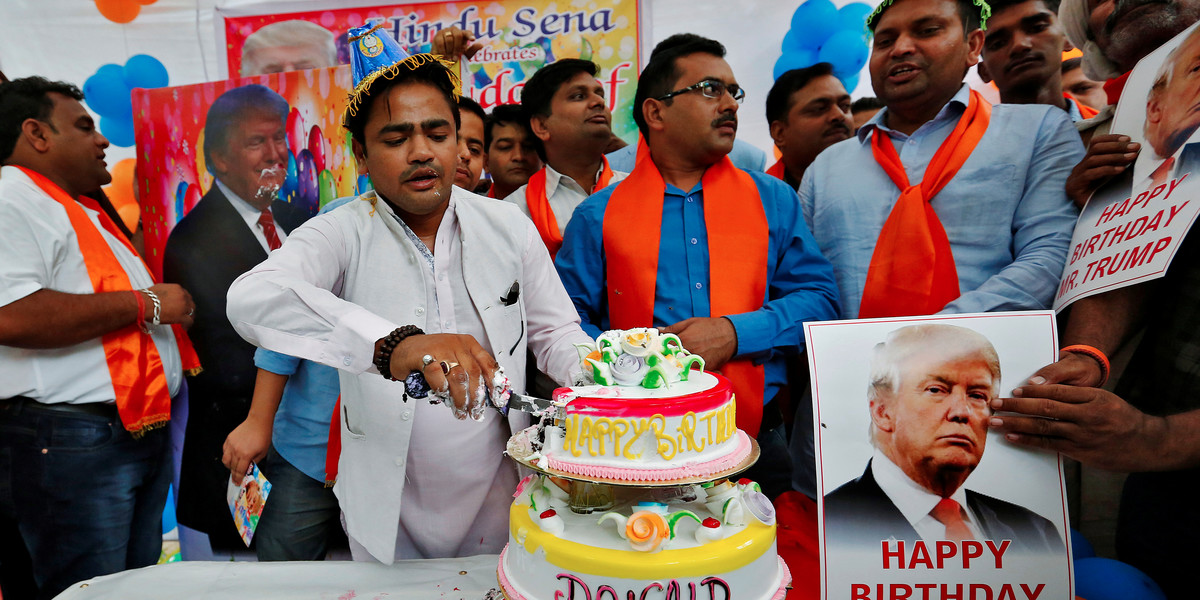 Members of Hindu Sena, a right-wing Hindu group, celebrating US Republican presidential candidate Donald Trump's birthday in New Delhi, India, on Tuesday.