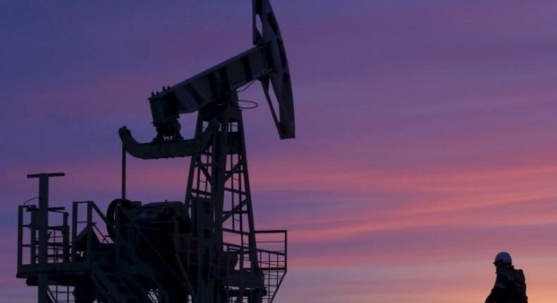 File photo of a worker walking past a pump jack on an oil field owned by Bashneft, Bashkortostan