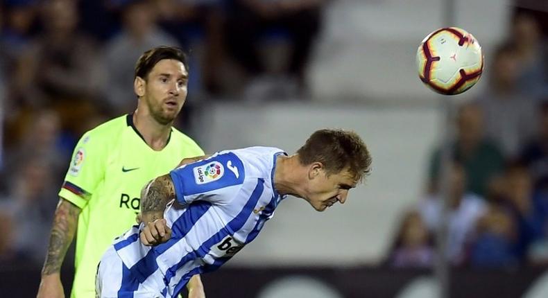 Watch this! Barcelona's Lionel Messi looks on as Leganes defender Raul Garcia clears the ball