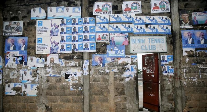 Election posters are seen pasted on a wall at the entrance to Benin Tennis Club, a day before the presidential election in Cotonou, March 5, 2016. REUTERS/Akintunde Akinleye
