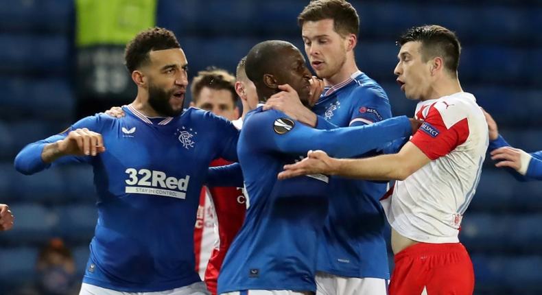 Slavia Prague's Ondrej Kudela (right) has been banned for racist behaviour towards Rangers player Glen Kamara (centre)