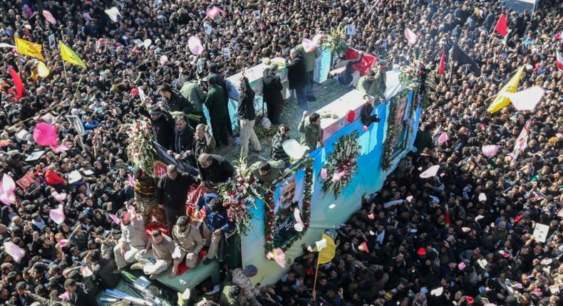 Iranian mourners gather in January 2020 around a vehicle carrying the coffin of slain top general Qasem Soleimani, whose killing by the United States a UN expert has concluded was unlawful