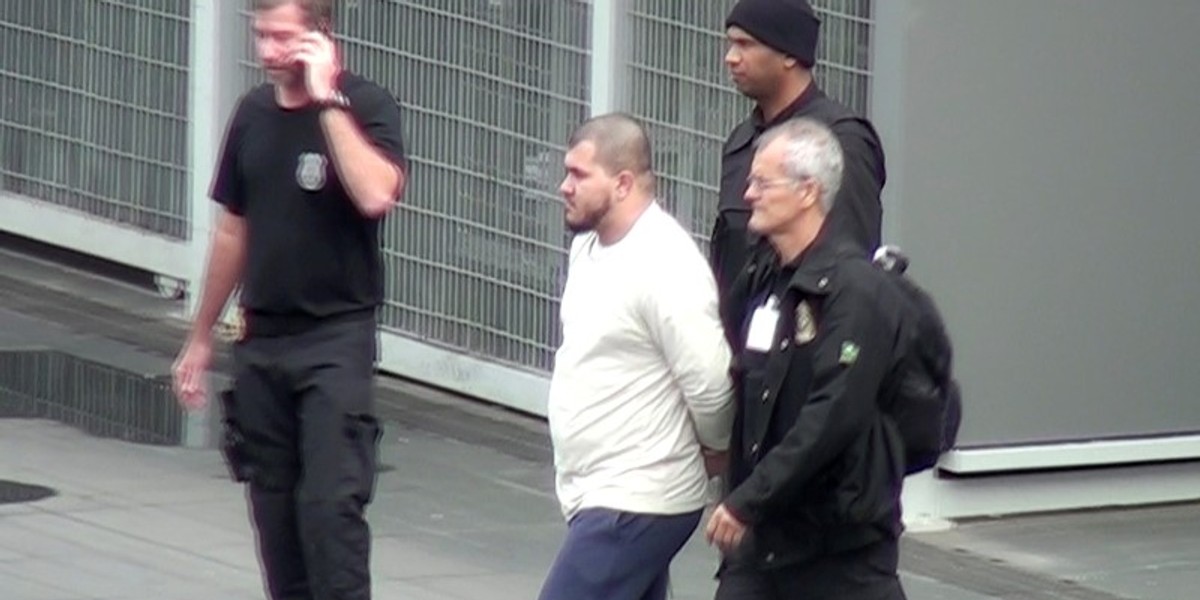 Brazilian Federal Police officers escort one of the 10 people they arrested on suspicions of ties to Islamic State in Sao Paulo