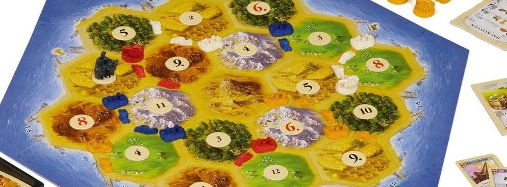 <strong>Osadnicy z Catanu</strong>
<br></br>
Gracze wcielają się w role tytułowych osadników, którzy osiedlają się na dziewiczej wyspie Catan. Ich zadaniem jest rozbudowa dróg i osad oraz zdobywanie kart rozwoju. Gra wymusza współpracę handlową w celu wzajemnej wymiany potrzebnych surowców. Rozgrywkę wygrywa osoba, która zdobędzie 10 punktów. Szkodę innym graczom można spowodować używając złodzieja, ale nie tylko. Można także blokować rozwój osady innego gracza i nie podejmować z nim handlu surowcami. Gra uczy zachowań ekonomicznych i zarządzania surowcami. 
<br></br>