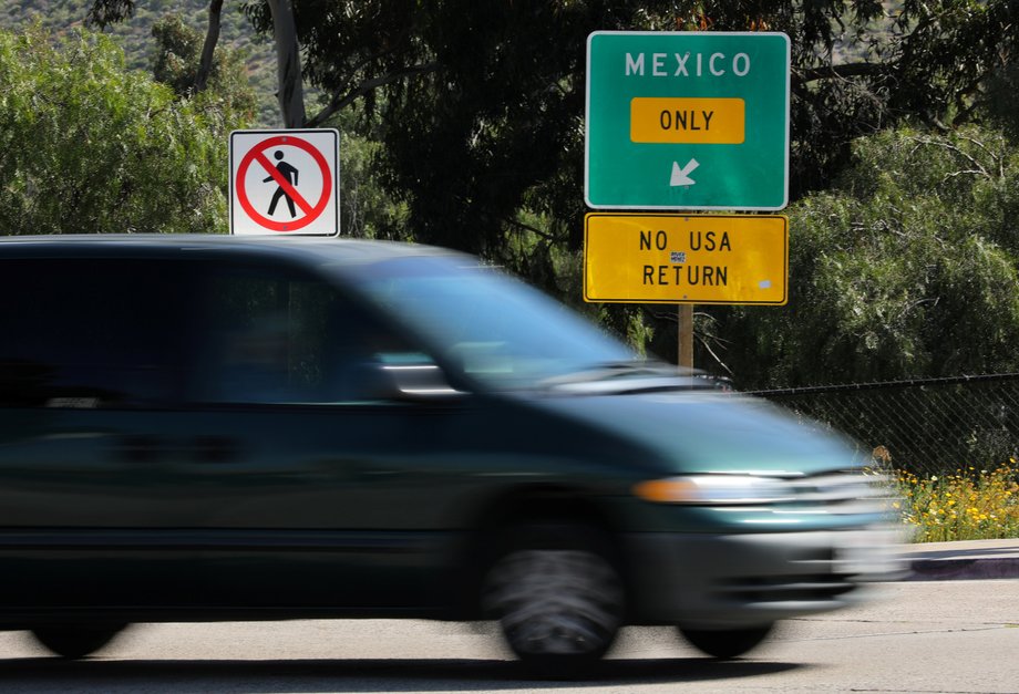 A vehicle travels past an exit sign directing traffic to the Mexican border crossing in San Ysidro, a district of San Diego, California, April 21, 2017.