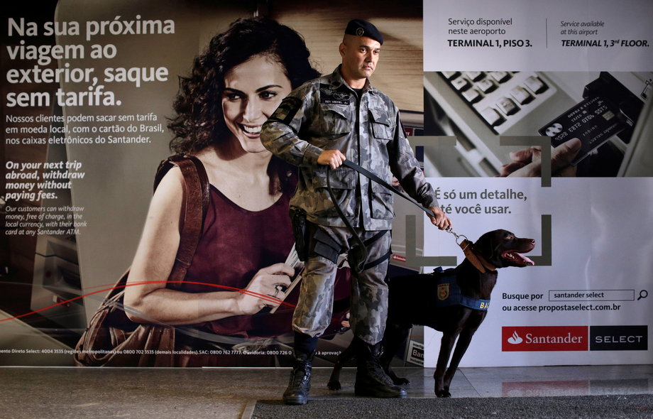 Soldiers of the military-police battalion and their dogs take part in an instructional exercise at Terminal 1 of the Tom Jobim International Airport in Rio de Janeiro, Brazil, May 25, 2016.