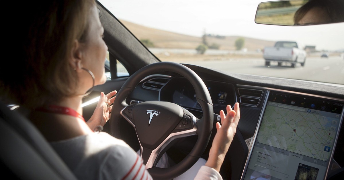 Tesla driver charged for appearing to be asleep with the seat fully ...