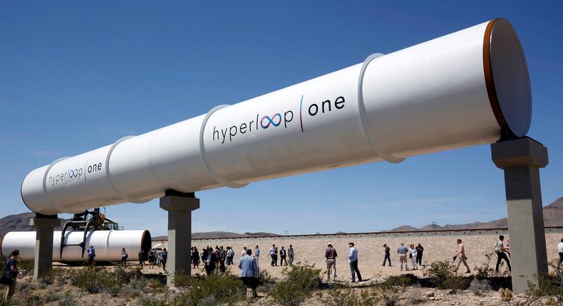 Journalists and guests look over tubes following a propulsion open-air test at Hyperloop One in North Las Vegas, Nevada, U.S. May 11, 2016.