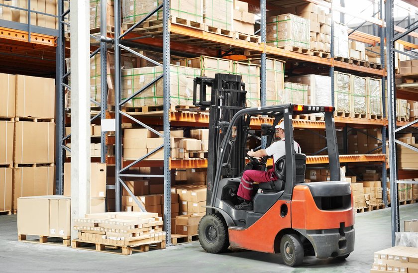 worker driver at warehouse forklift loader works