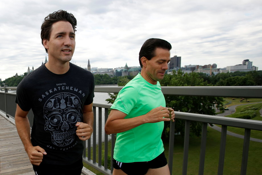 Canada's Prime Minister Justin Trudeau, left, runs with Mexico's President Enrique Pena Nieto across the Alexandra Bridge from Ottawa to Gatineau, Quebec, Canada, June 28, 2016.