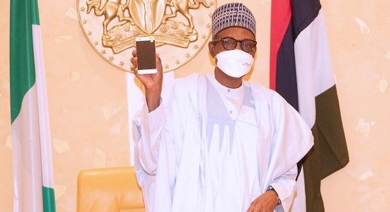 President Muhammadu Buhari receives first made in Nigeria cell phone. [The Nation]