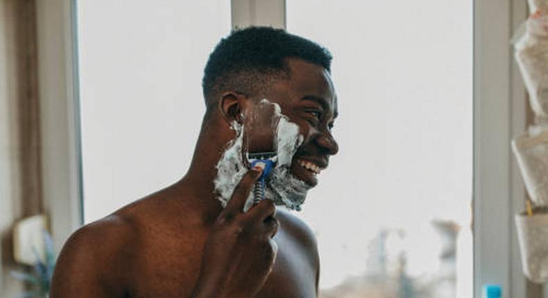 Photo of a man shaving his beard