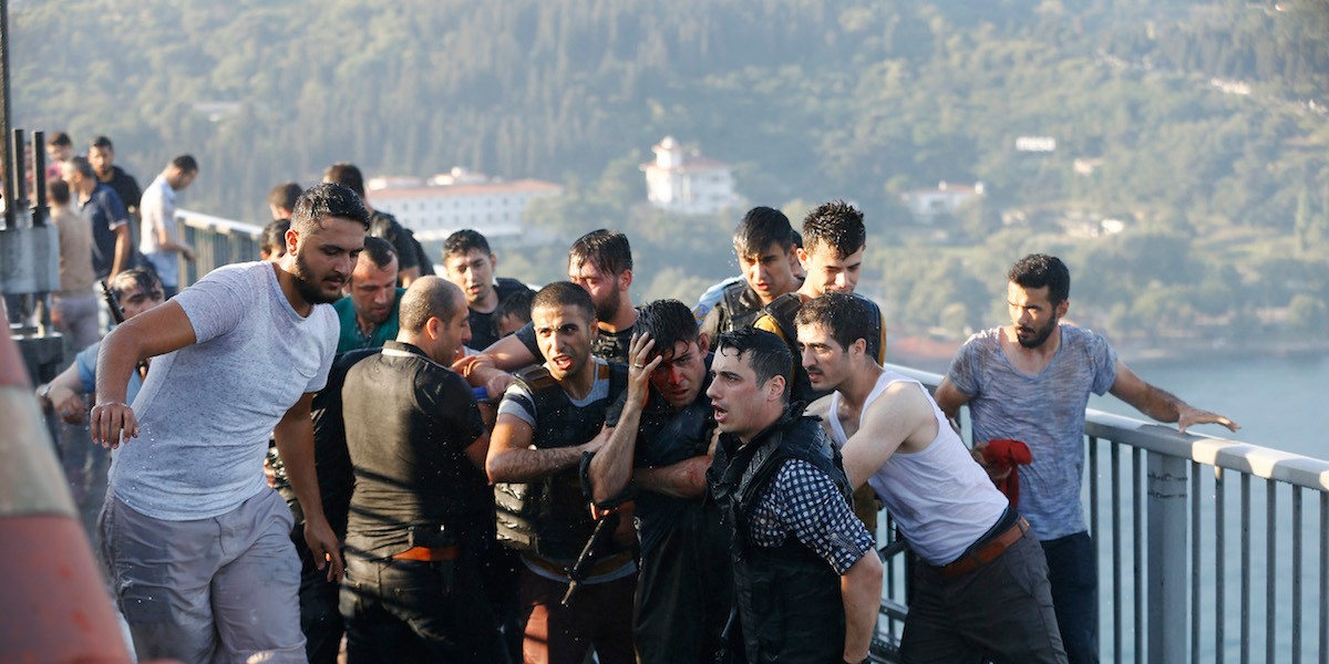 Policemen protect a soldier from the mob after troops involved in the coup surrendered on the Bosphorus Bridge in Istanbul, Turkey, July 16, 2016.