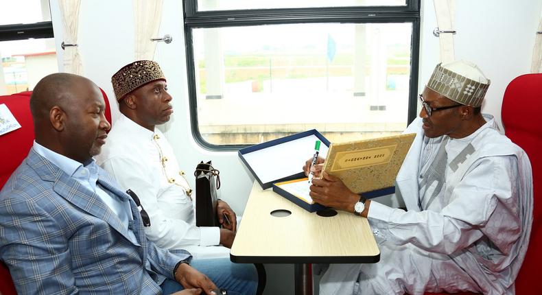 President Muhammadu Buhari takes a train ride with the Minister of Transport, Rotimi Amaechi and the Minsiter of state for Aviation, Hadi Sarika.