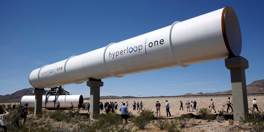 Journalists and guests look over tubes following a propulsion open-air test at Hyperloop One in North Las Vegas, Nevada, U.S. May 11, 2016.
