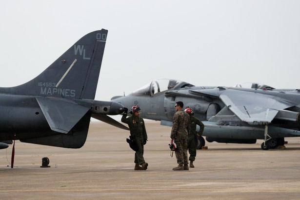 U.S. Air Force soldiers chat in front of a U.S. Marines McDonnell Douglas AV-8B Harrier II during the Max Thunder Air Exercise, a bilateral training exercise between the South Korean and U.S. Air Force, at a U.S. air base in Gunsan, South Korea, on Thursday, April 20, 2017. U.S. Vice President Mike Pence issued a fresh warning to North Korea from the deck of a U.S. aircraft carrier in Japan, hours after reports emerged that the approaching "armada" that President Donald Trump touted last week was still thousands of miles away. Photographer: SeongJoon Cho/Bloomberg