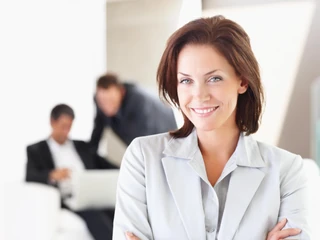 A Happy business woman with other colleagues in the background