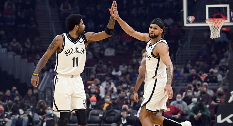 Kyrie Irving #11 and Patty Mills #8 of the Brooklyn Nets.