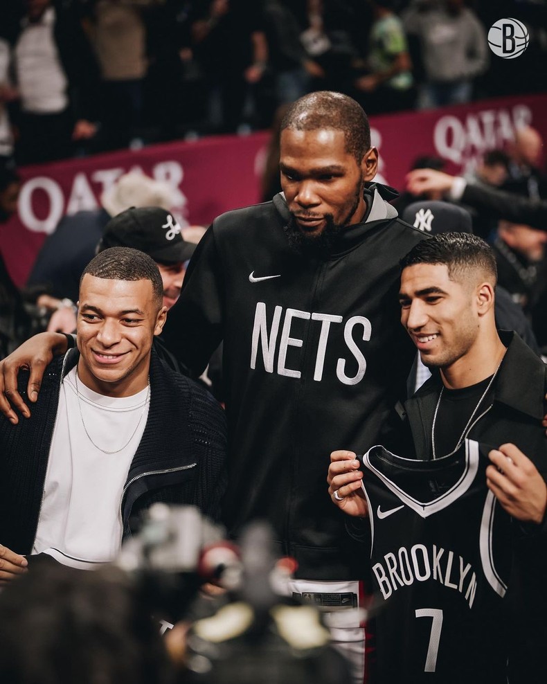 Mbappe hugged Durant and was given a Brooklyn Nets jersey as they posed for photos with Hakimi.