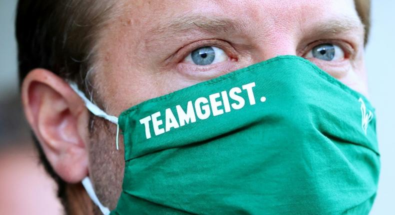 The Werder Bremen squad, under head coach Florian Kohfeldt seen here wearing a face mask bearing the logo team spirit, has also agreed to another pay-cut