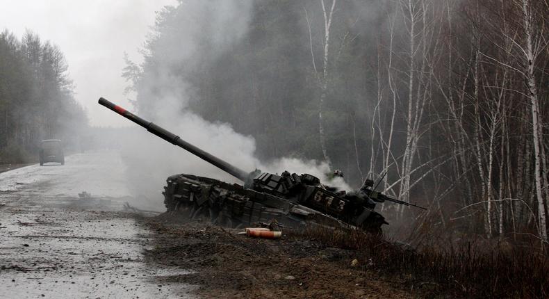 Smoke rises from a Russian tank damaged during the early days of Putin's invasion of Ukraine.