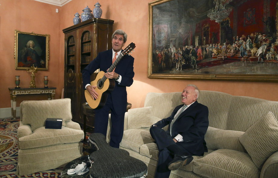 SPAIN: Kerry poses with a guitar, given as a present by Spanish Foreign Minister Jose Manuel Garcia-Margallo, during a meeting at the Foreign Ministry in Madrid, October 18, 2015.