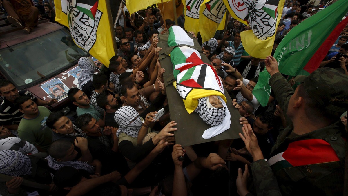 Mourners carry the body of 13-year-old Palestinian boy Abdel-Rahman Abeidallah, who was shot by Isra