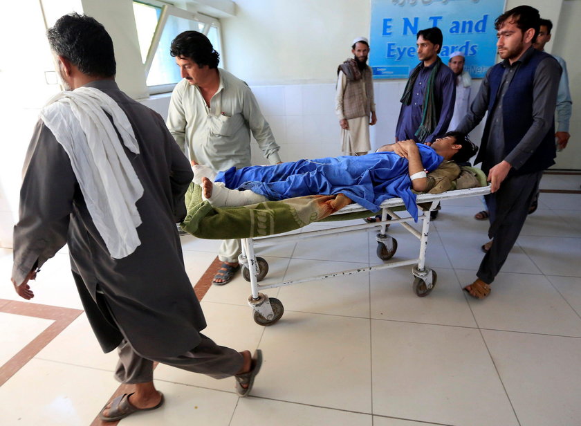 An injured man receives treatment in a hospital, after blasts at a sports stadium, in Jalalabad city