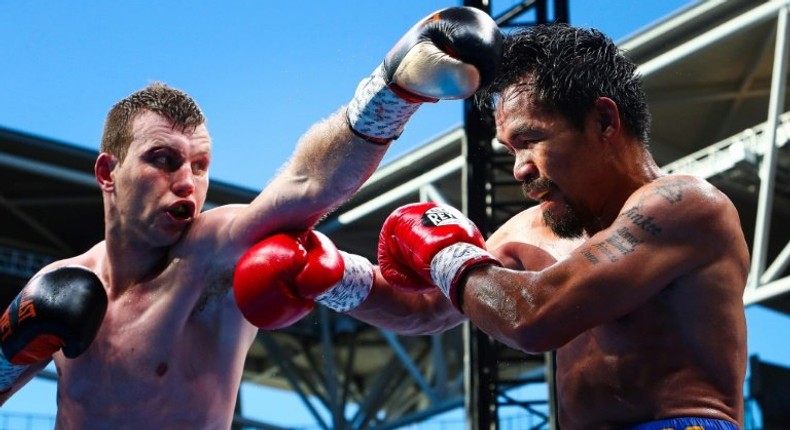 This file photo taken on July 2, 2017 shows Manny Pacquiao of the Philippines (R) fighting Jeff Horn of Australia during their World Boxing Organization boxing bout at Suncorp Stadium in Brisbane