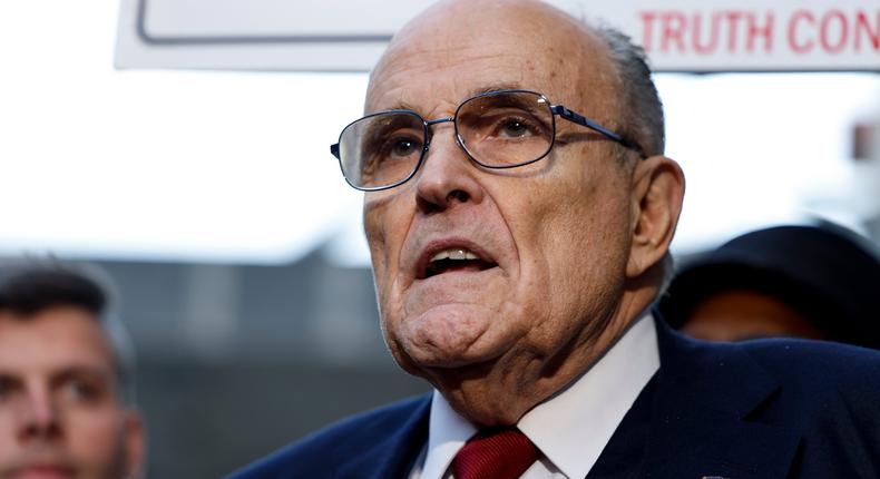 Former Mayor of New York Rudy Giuliani talks to reporters as he leaves after his defamation trial, where a jury awarded $148 million in damages to two former Georgia election workers.Anna Moneymaker/ Getty Images