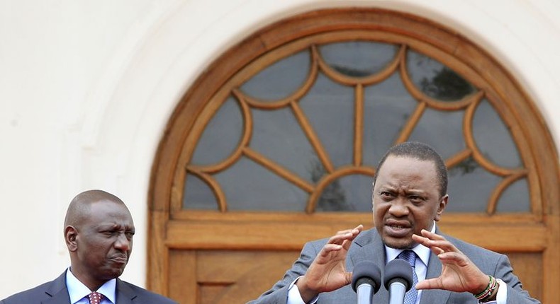 Kenya's President Uhuru Kenyatta (R) addresses a news conference next to his deputy William Ruto at State House in Nairobi July 21, 2015 to provide an update on U.S. President Barack Obama's scheduled visit later this week. REUTERS/Noor Khamis